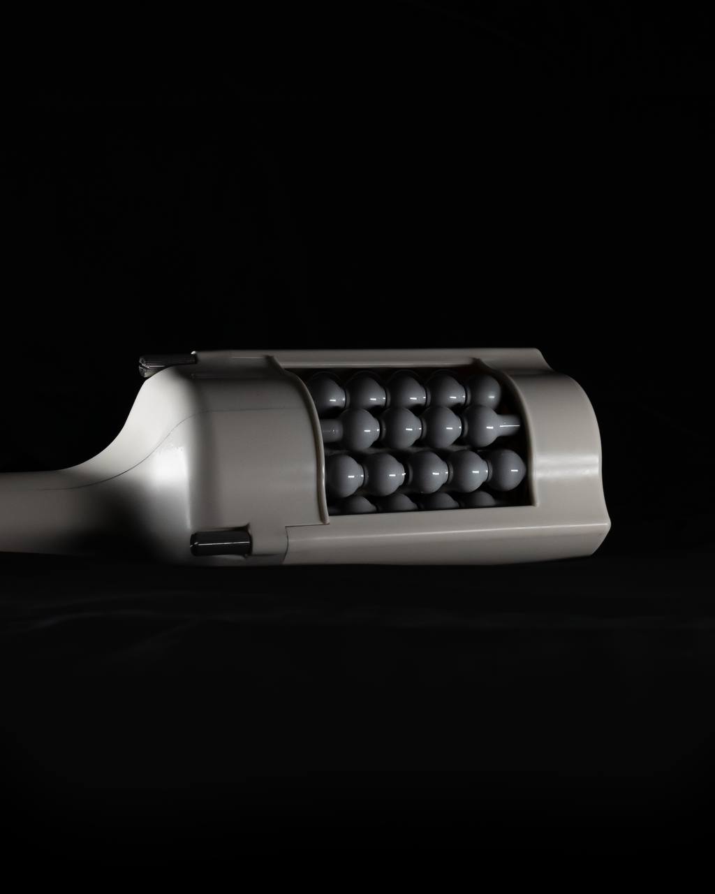Expert holding T-Shape 2 handpiece for lymphatic drainage massage NYC at Lumera Skin Lab.