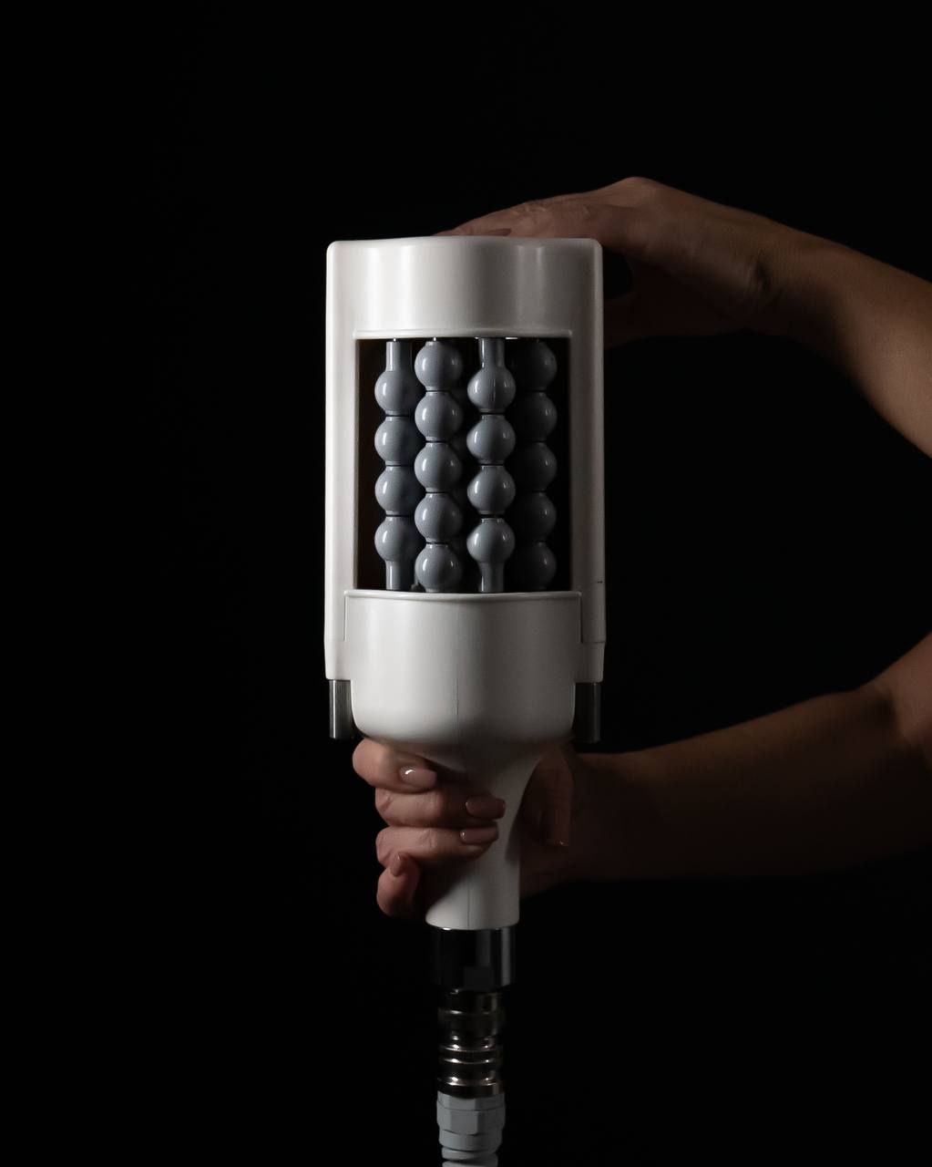 Expert holding T-Shape 2 handpiece for lymphatic drainage massage NYC at Lumera Skin Lab.